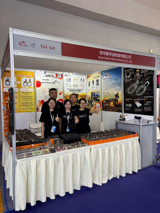 SAFETi team and titanium motorcycle parts at Booth N4-64, CIMAMotor 2026 in Chongqing.